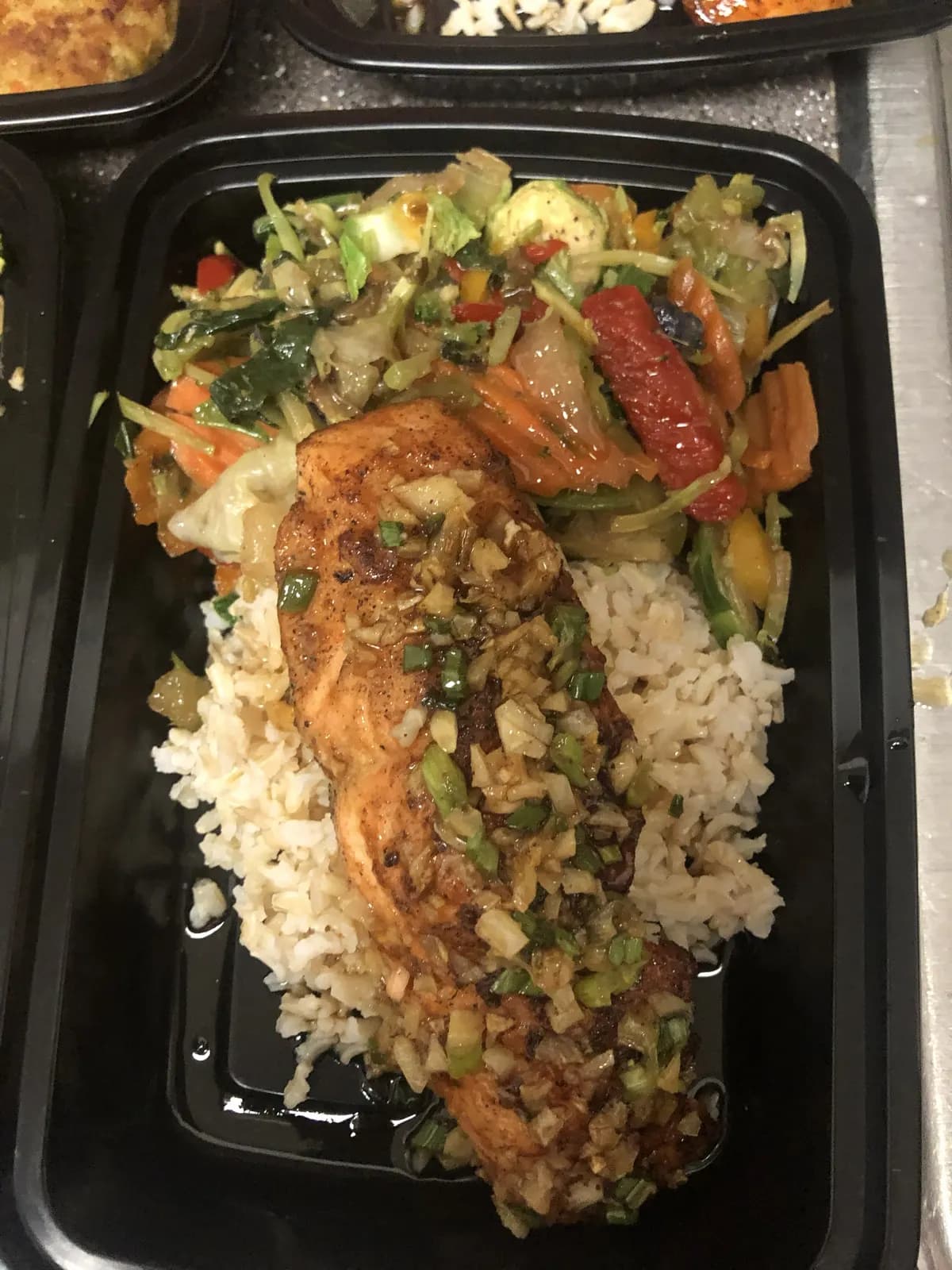 Salmon meal plan over rice and vegetables